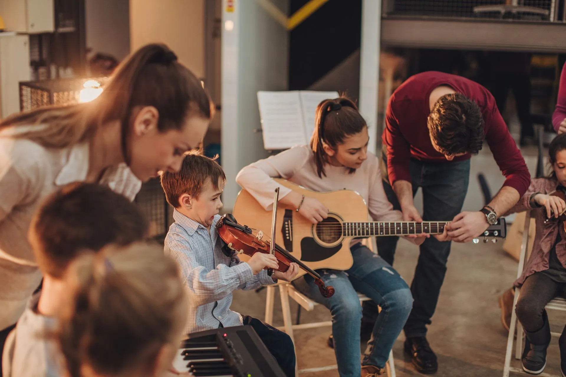 boy play violin in music class at learn the art with all student and teacher