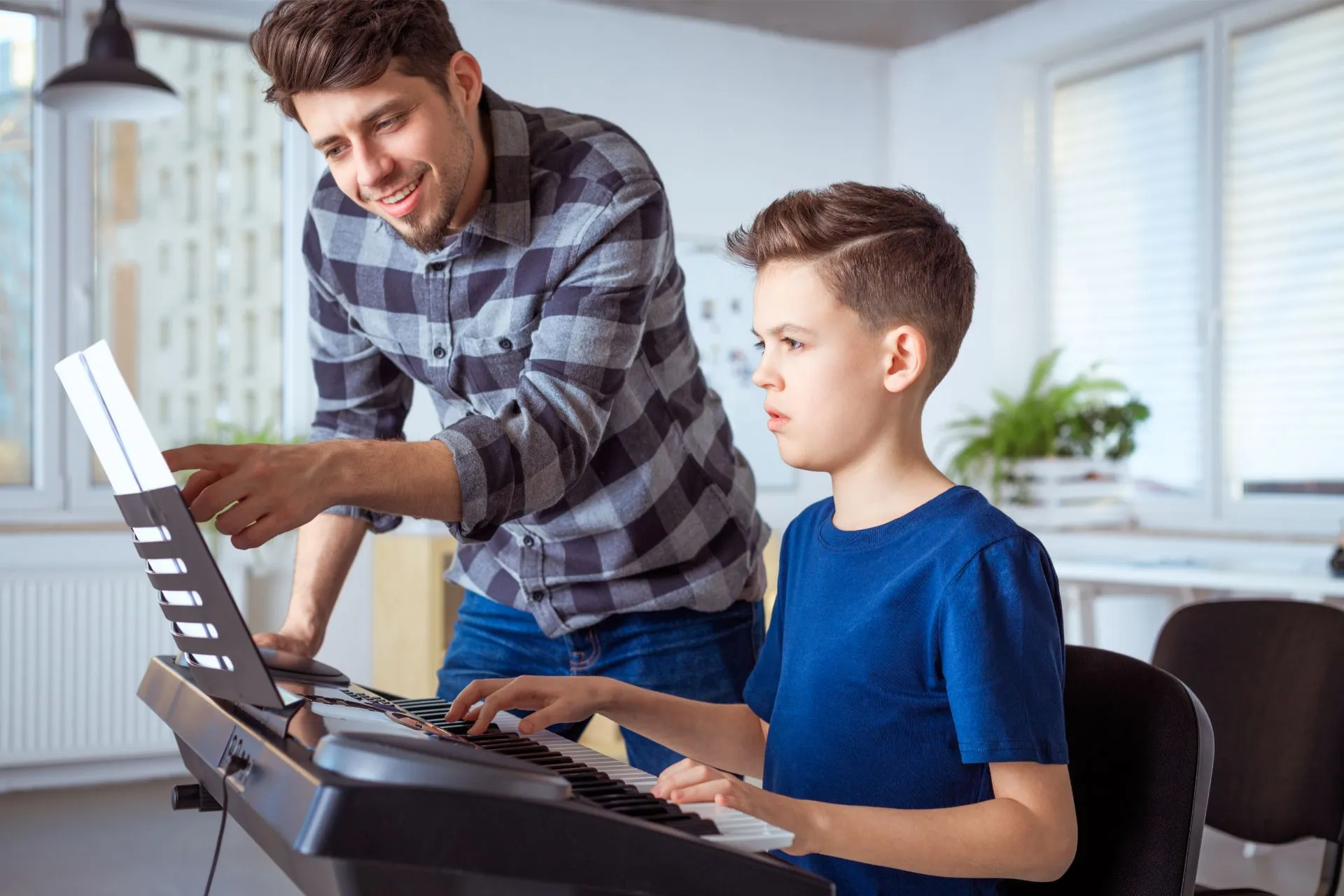 boy learn the piano lessons by teacher at learn the art