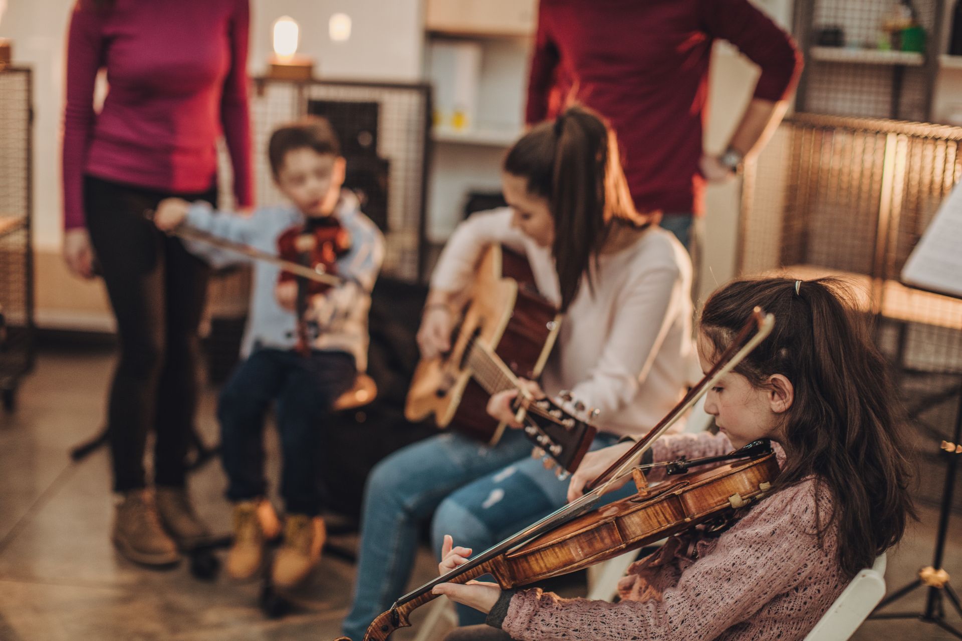 teacher and students playing music instrument in music class at learn the art