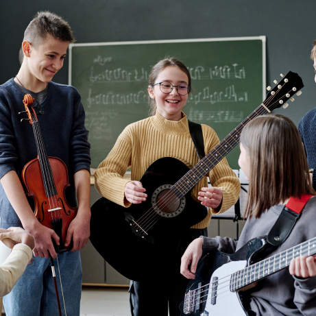 students playing music instrument in music class at learn the art