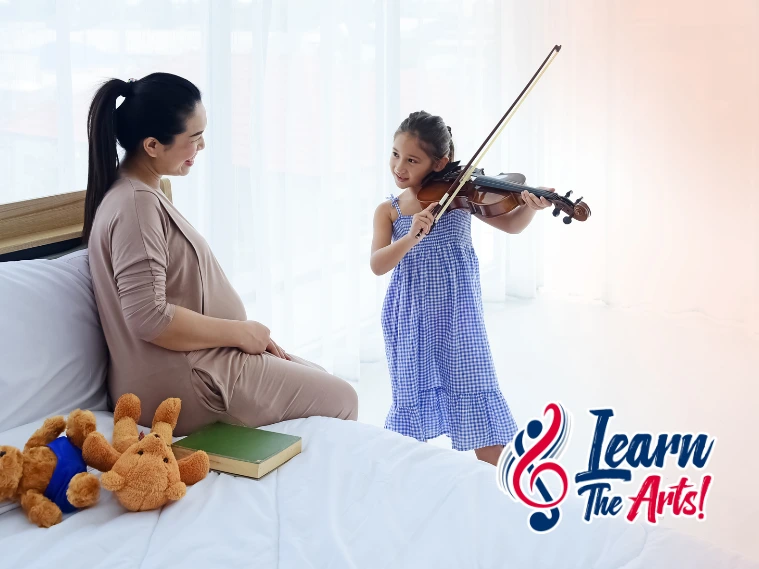 A smiling child playing a violin with a parent cheering proudly