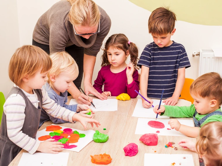 Children participating in engaging art classes, painting and drawing in a bright, creative classroom environment