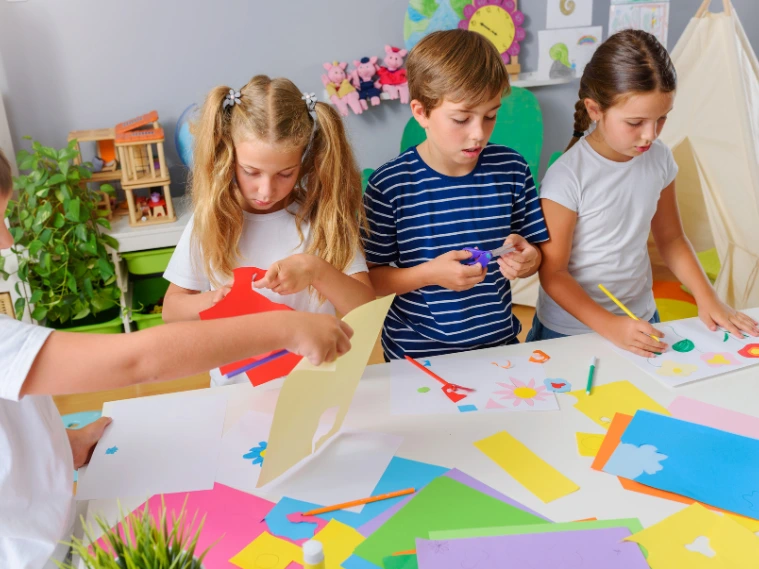 Kids participating in unique art classes, creating mixed-media and craft projects in a vibrant, supportive studio environment