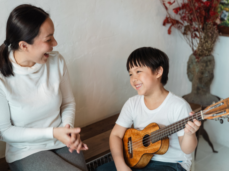 Beginner learning ukulele chords in music class