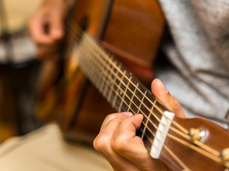 Close-up of guitar strings and frets used to explain music tabs for beginners