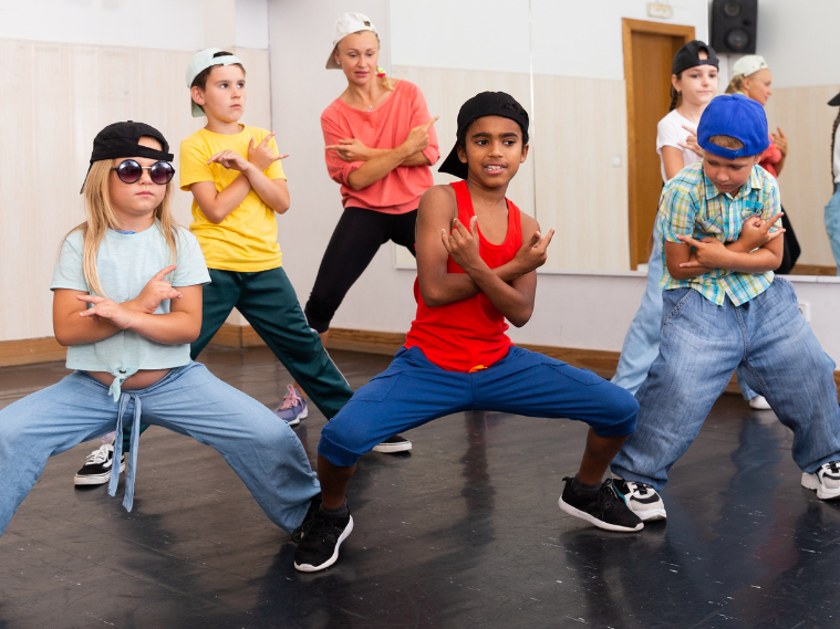 Kids performing hip hop dance moves during a practice session