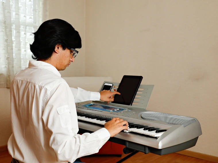 Adult beginner practicing piano notes during a lesson.