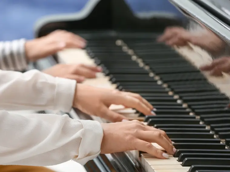 Close-up of hand placement on piano showing correct beginner technique