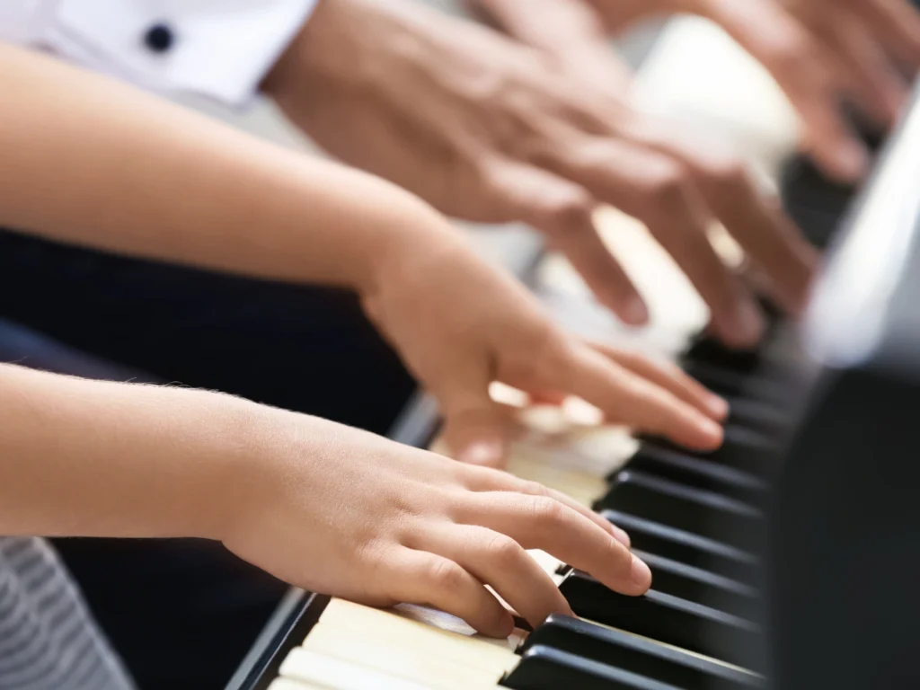 Close-up of hands practicing piano keys during first lesson in Nevada