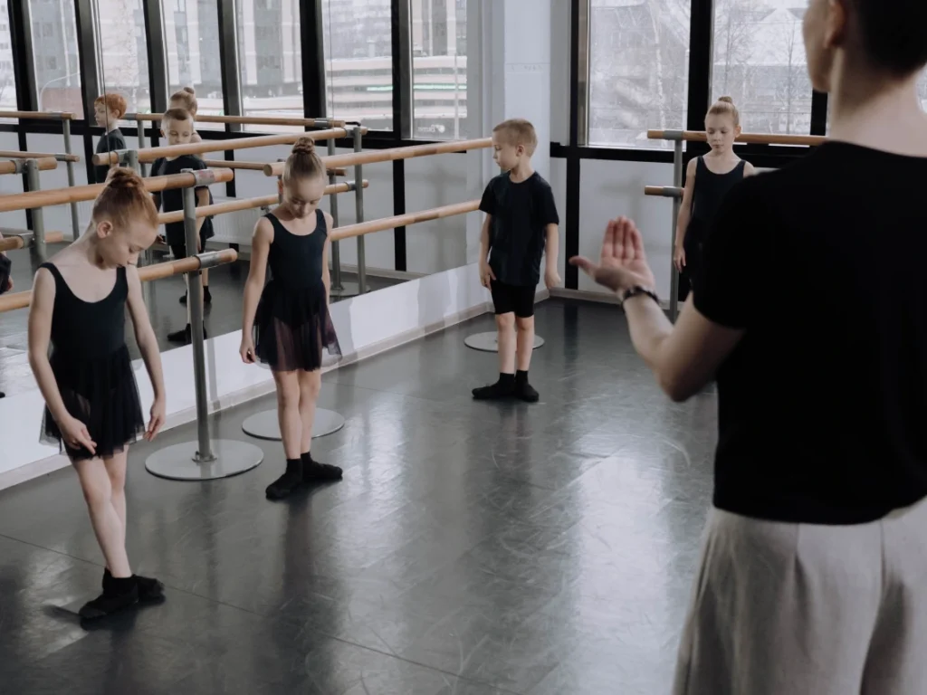 Dance instructor guiding beginner students through choreography during a group dance class in Westminster, CA studio environment