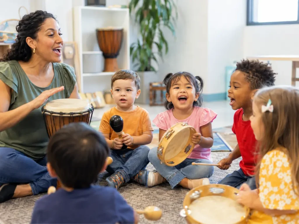 Preschool children participating in music lessons in Gilbert, Arizona using drums, tambourines, and singing activities in a classroom setting
