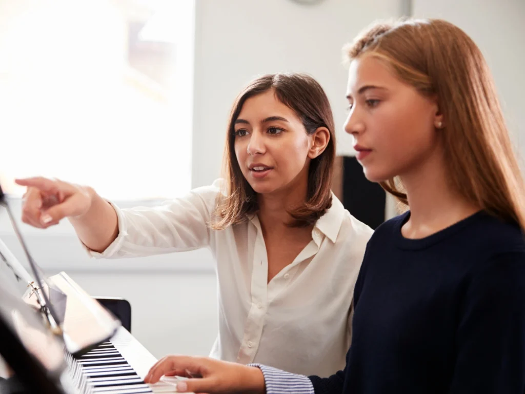 Student practicing piano during piano lessons in Las Vegas, Nevada with instructor guidance