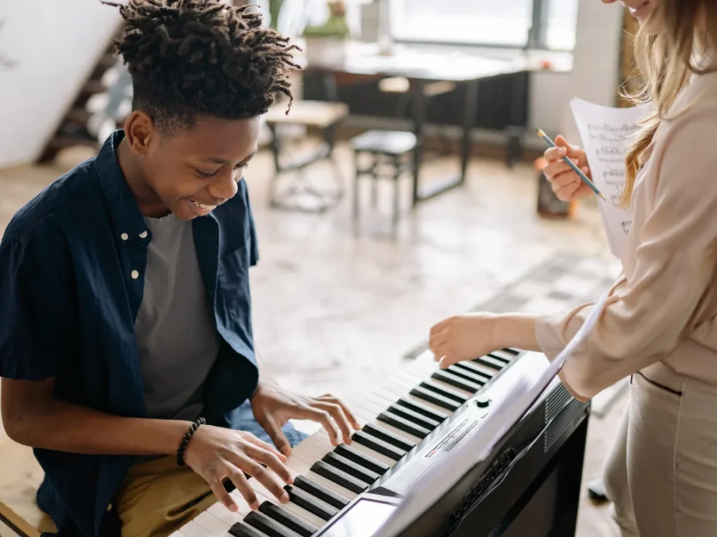 Young beginner practicing piano during music lessons in Gilbert, Arizona classroom setting