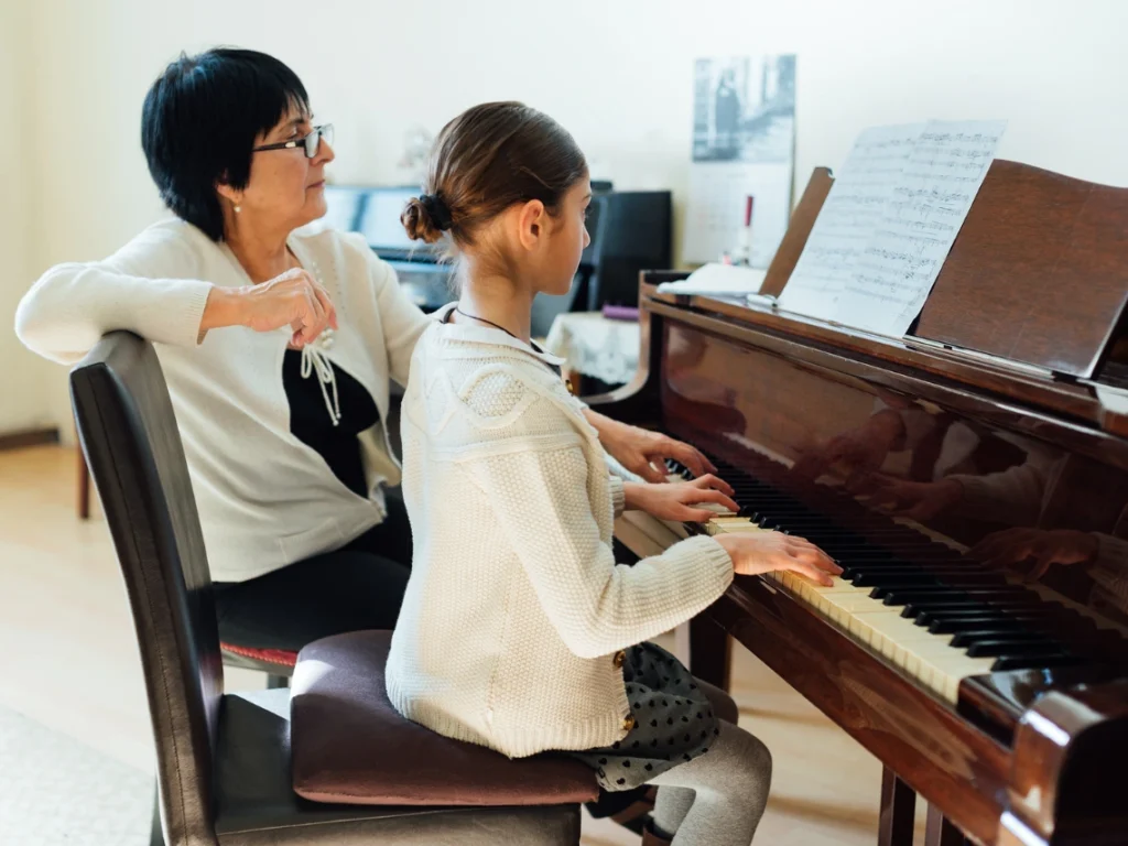 Beginner student taking piano lessons in Gilbert Arizona with a private instructor in a music studio.