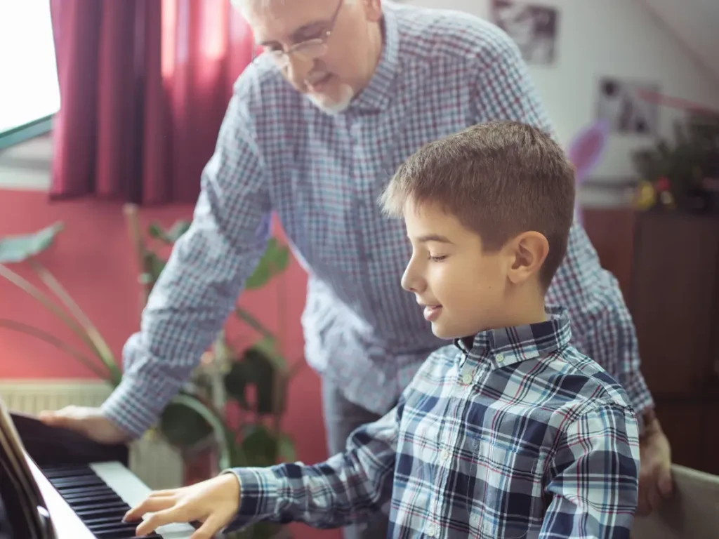 Child practicing piano with instructor during a one-on-one lesson in Gilbert, Arizona music studio