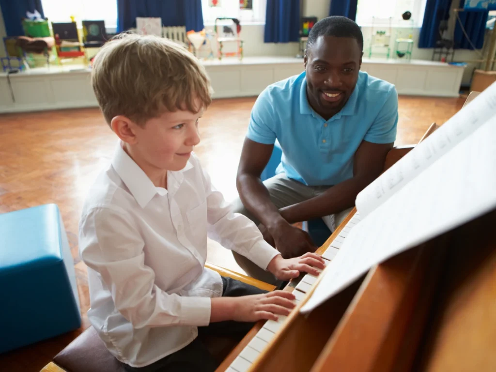 Piano instructor teaching a beginner student proper hand positioning during a piano lesson in Las Vegas, Nevada