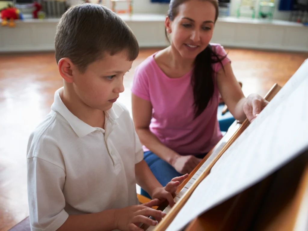 Student practicing piano with sheet music during a structured music lesson in Las Vegas, NV