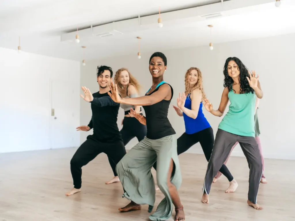 Adult students learning hip hop choreography inside a professional dance studio in Las Vegas, NV during a group class.