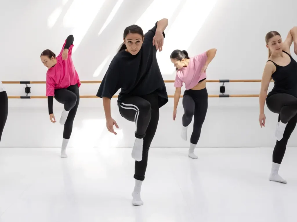 Close-up of a dancer's footwork during an adult beginner hip hop dance class in a modern Las Vegas studio setting.