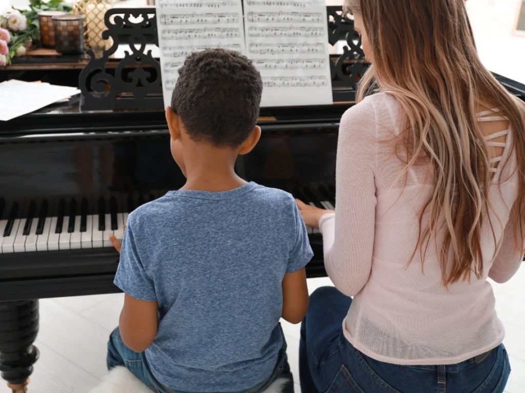 Student learning piano with an experienced instructor in a professional Westminster, CA music studio setting