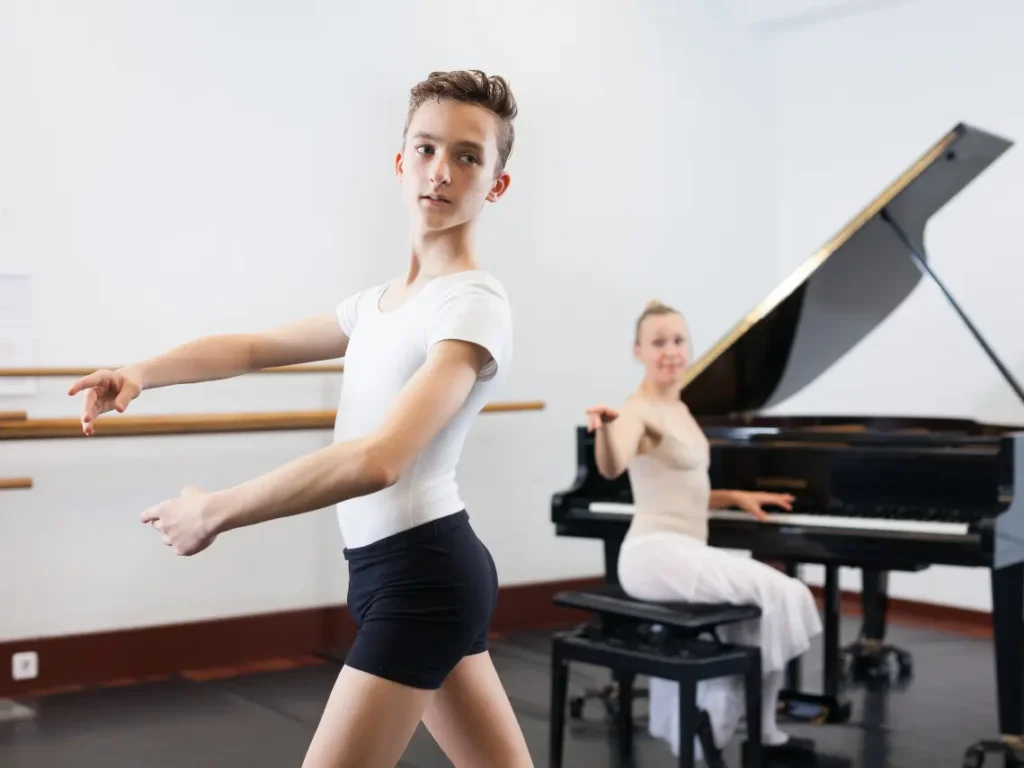 Student practicing piano while another practices dance choreography in adjacent studios in Las Vegas