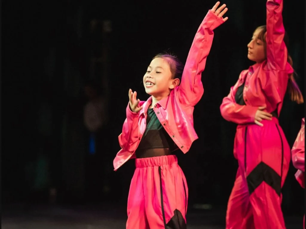 Students performing on stage at a Westminster Arts Academy showcase or recital event